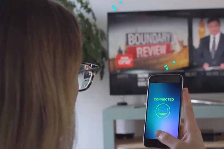 woman looking at smart phone with the words connected shown on screen