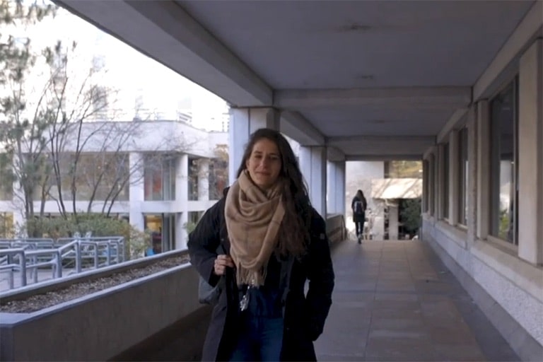 Sharon walking through hallway