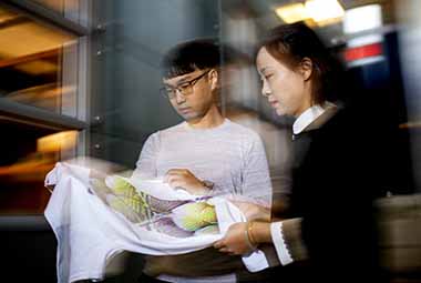 professor and phd student viewing design on t-shirt for invisibility to networks