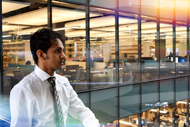 student posing with interior of ISEC in background