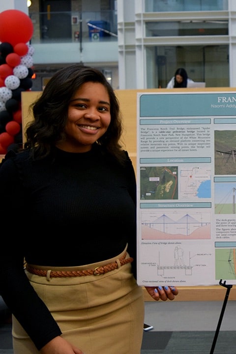 student with research poster