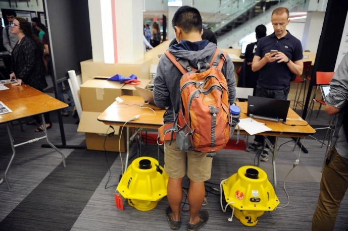 student looking at table at a research fair