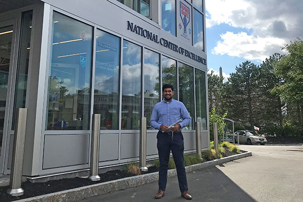student standing outside in front of his co-op employer building