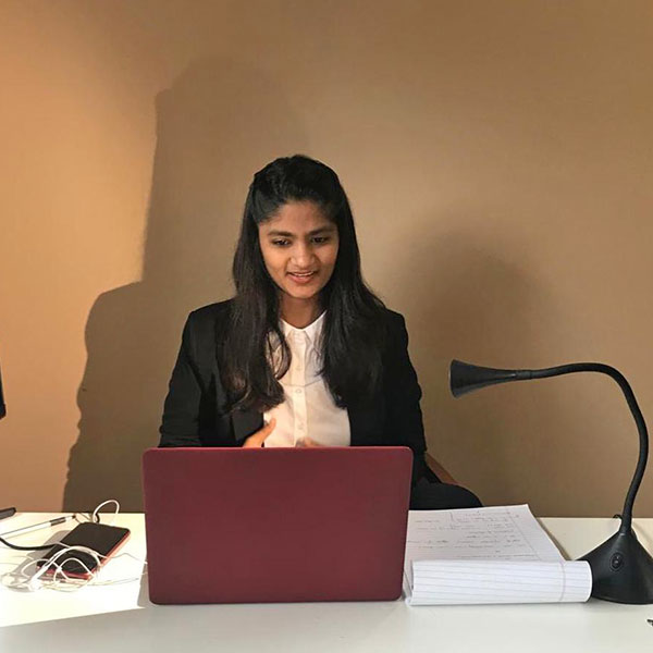 student at desk with laptop
