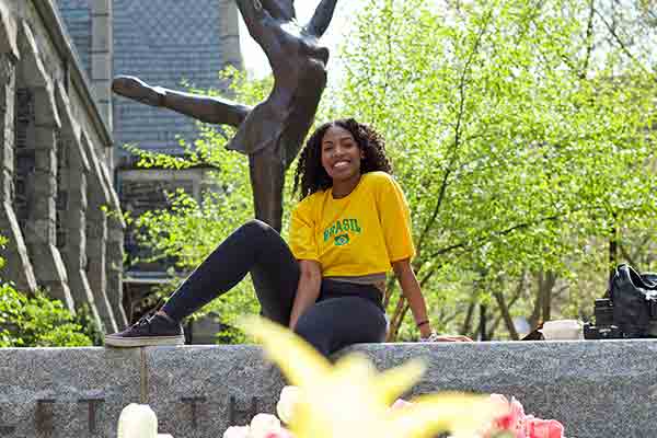 student sitting on wall at Northeastern University