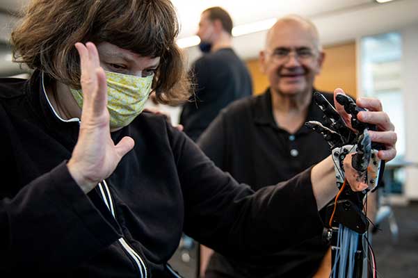 aimi Lard, who is blind and deaf, feels the TATUM robotic hand