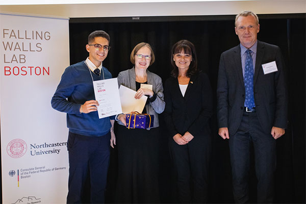 student accepting award on stage at event