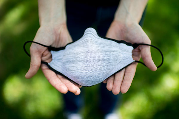 two hands showing full mask