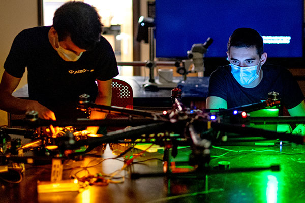 two male students working on drone project