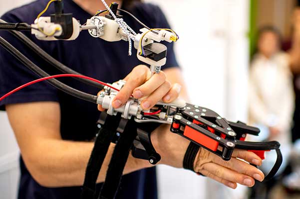 Robotic arm attached to Peter Whitney's arm.